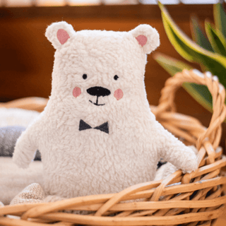 Flauschiger Plüsch-Eisbär Wim von ava&yves mit Fliege in Weidenkorb. Kuscheltier.