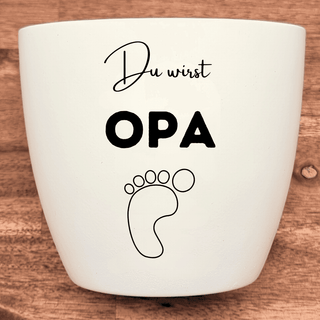 Weißer Blumentopf mit dem Aufdruck "Du wirst Opa" und einem Babyfußabdruck. Geschenk zur Schwangerschaft für den werdenden...